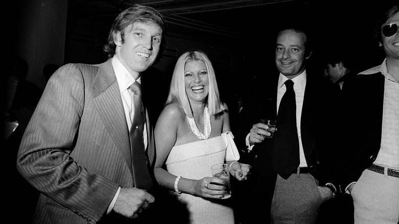 Young Donald Trump and Ivana Trump laughing in a club with two men