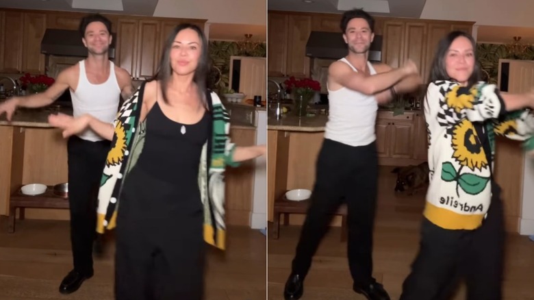 Sasha Farber and Janel Parrish dancing in a kitchen.