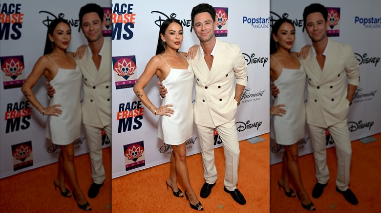 Sasha Farber posing with his arm around Janel Parrish.