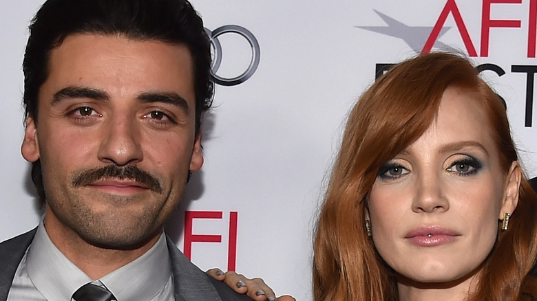 Jessica Chastain and Oscar Isaac pose for a picture at a movie premiere