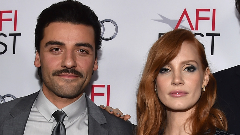 Jessica Chastain and Oscar Isaac pose for a picture at a movie premiere