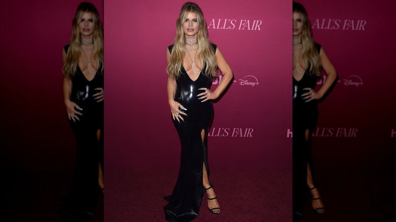 Jessica Simpson posing in a black latex dress.