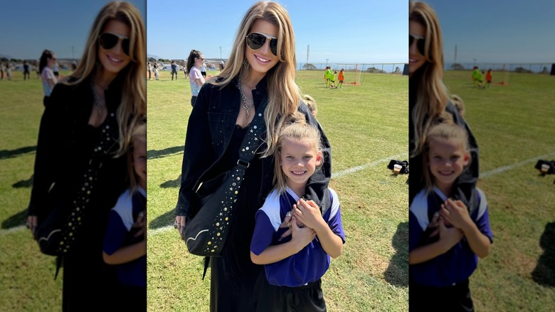 Jessica Simpson posing on a soccer field with her daughter Birdie Mae.