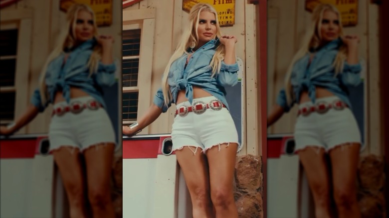 Jessica Simpson wearing cut-off shorts and a tied-up top.