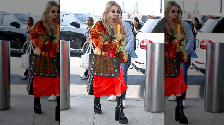 Jessica Simpson wearing a multicolored velvet jacket and red dress.