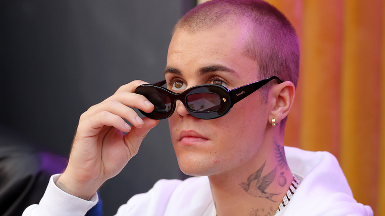 Justin Bieber looking over his sunglasses