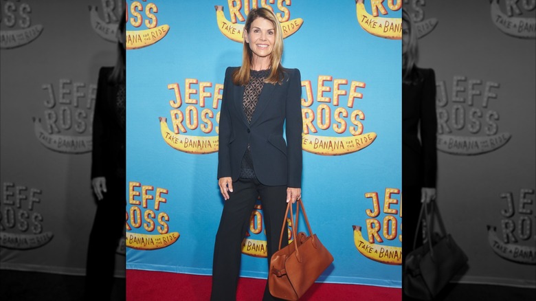 Lori Loughlin posing on step-and-repeat for "Jeff Ross: Take a Banana for the Ride"