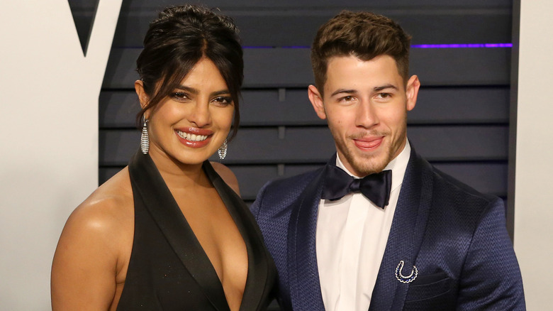 Nick Jonas and Priyanka Chopra posing for photos