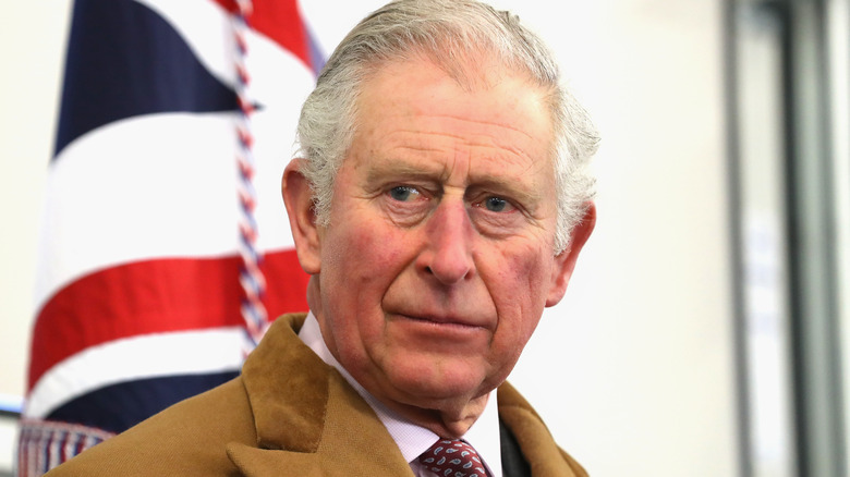 King Charles III in front of Union Jack flag