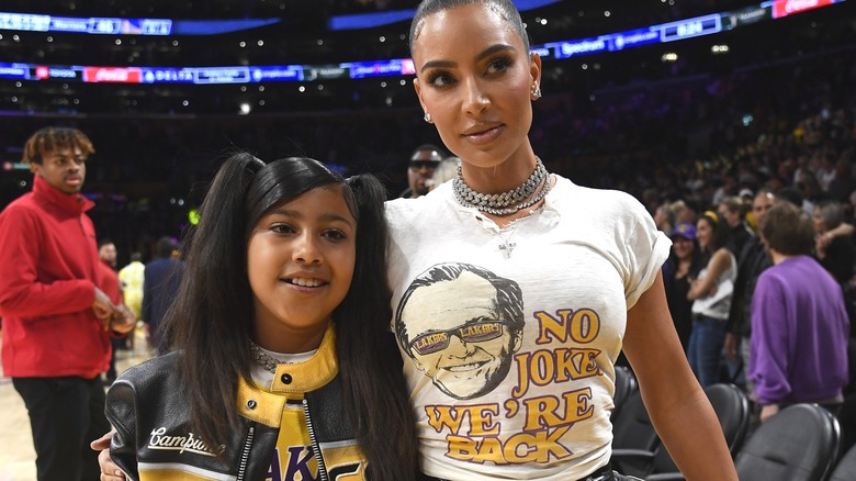 Kim Kardashian and North West at basketball game