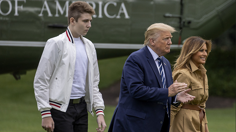Barron Trump, Donald Trump, and Melania Trump walking on the South Lawn of the White House