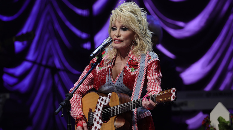 Dolly Parton playing guitar