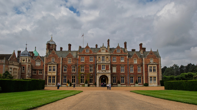 Photo of Sandringham House, which was Queen Elizabeth II's favourite property, with tourists stood outside