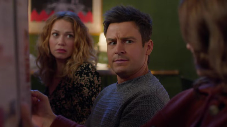 Tyler Hynes in between Bethany Joy Lenz and another woman