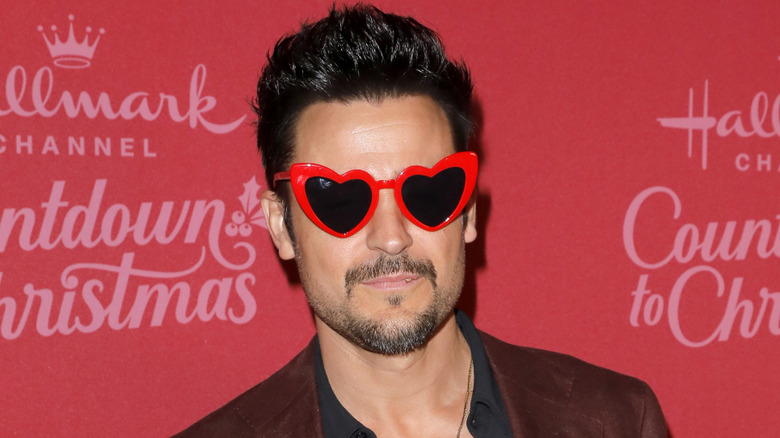 Tyler Hynes wearing heart-shaped sunglasses