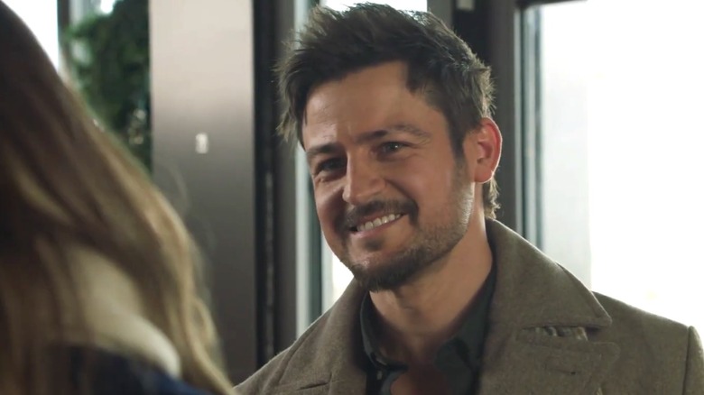Tyler Hynes smiling during a scene.