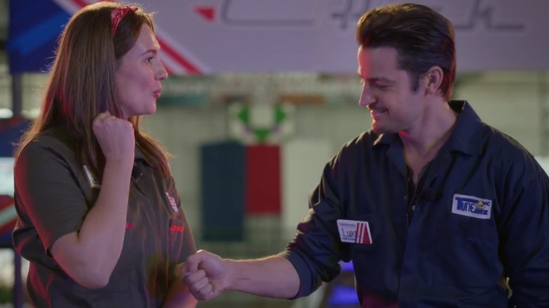 Katherine Barrell and Tyler Hynes wearing mechanic jumpsuits