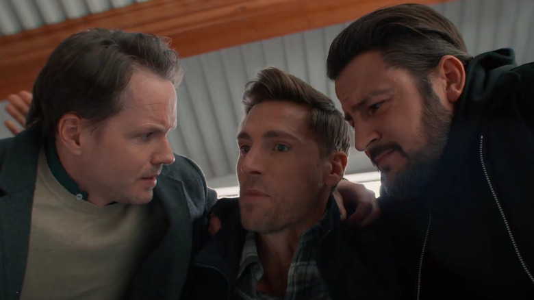 Paul Campbell, Andrew Walker, and Tyler Hynes huddling together