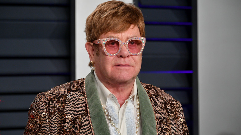 Elton John wearing colored glasses