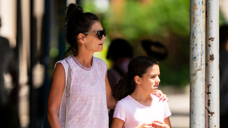 Katie Holmes arm around Suri Cruise