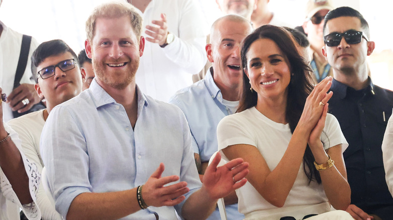 Prince Harry and Meghan Markle clapping