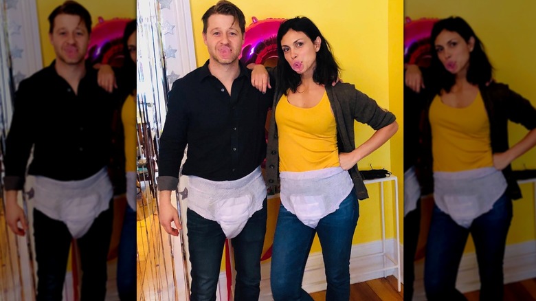 Ben McKenzie and Morena Baccarin wear adult diapers and pose with pacifiers in their mouths.