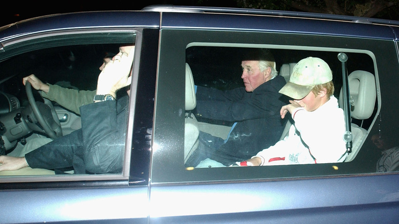 Prince Harry in car surrounded by paparazzi