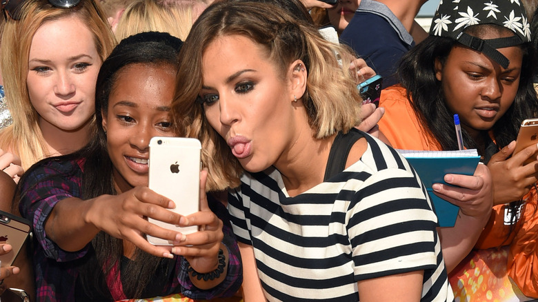 Caroline Flack taking selfies with fans