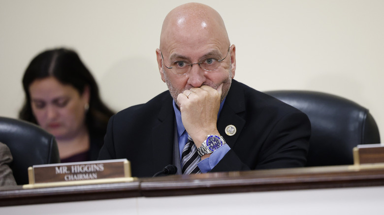 Clay Higgins looking concerned with his chin resting on his hand