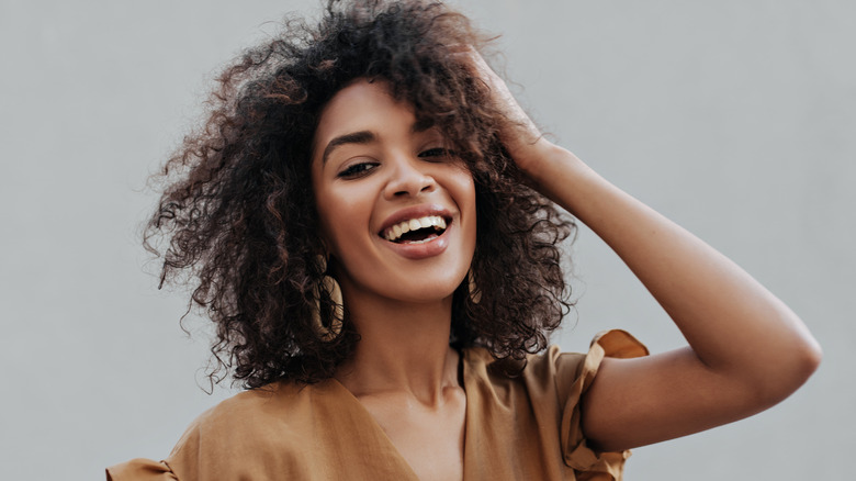 Curly-haired woman laughing