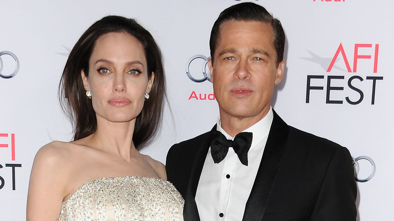 Angelina Jolie and Brad Pitt stand side by side