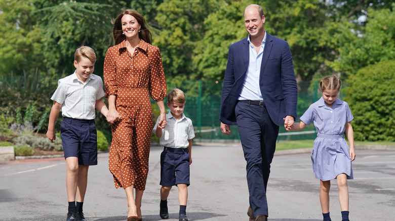 The Wales family walking and holding hands 