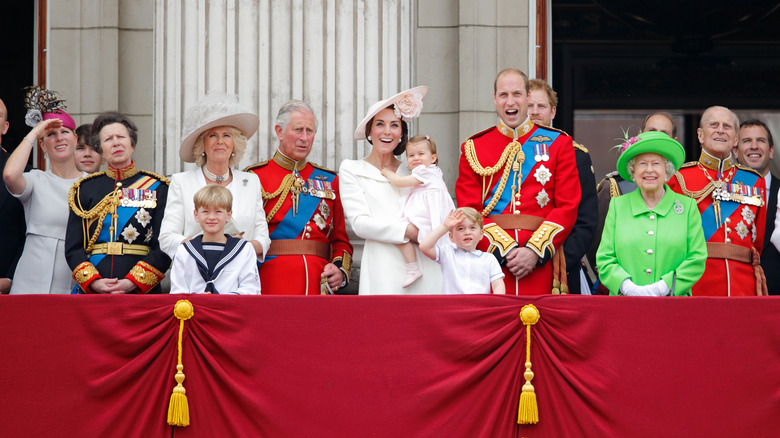 The royal family standing on a balcony
