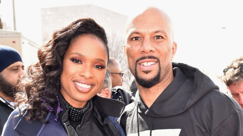 Jennifer Hudson and Common smiling together at an outdoor event