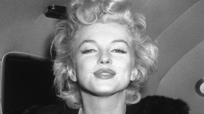 Marilyn Monroe squinting and slightly smiling