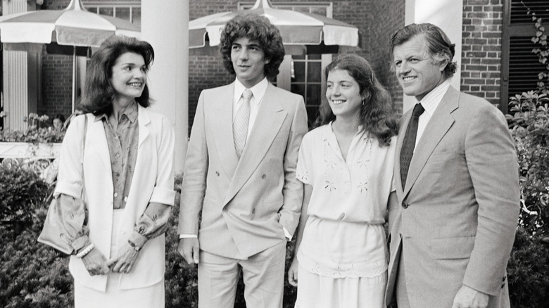 Jackie Kennedy Onassis, JFK Jr., Caroline Kennedy, and Ted Kennedy smiling for photo