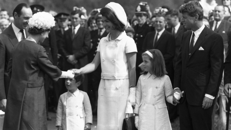 Jackie Kennedy shaking Queen Elizabeth II's hand in 1965