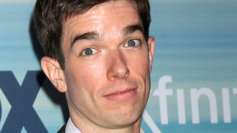 John Mulaney posing at event