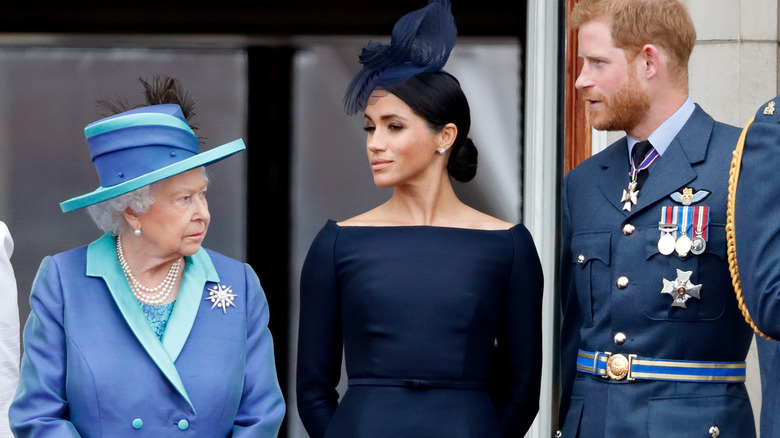 Queen Elizabeth II, Meghan Markle, and Prince Harry on the palace balcony