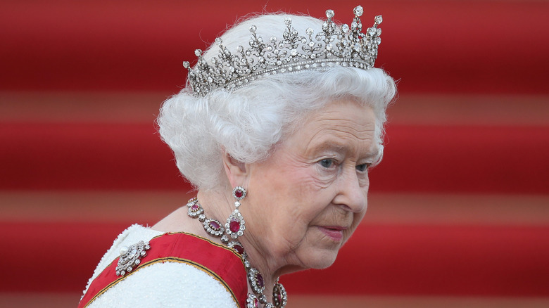 Queen Elizabeth in profile smiling slightly wearing the Girls of Great Britain and Ireland tiara