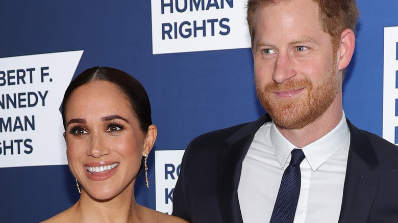 Prince Harry and Meghan Markle smiling at the camera