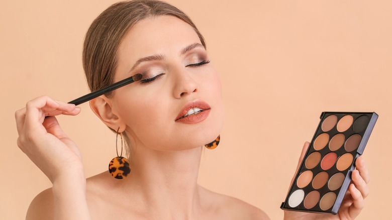 Woman applying eyeshadow