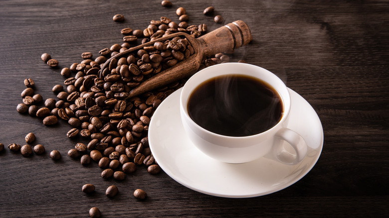 coffee cup beside coffee beans