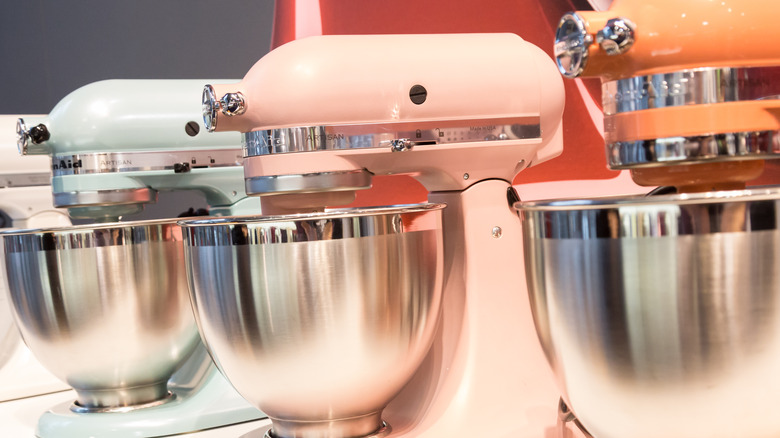 Three KitchenAid stand mixers lined up