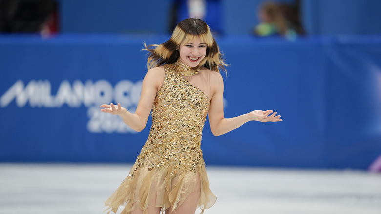 Alysa Liu smiling on the ice after performing at the 2026 Milan Cortina Winter Olympics