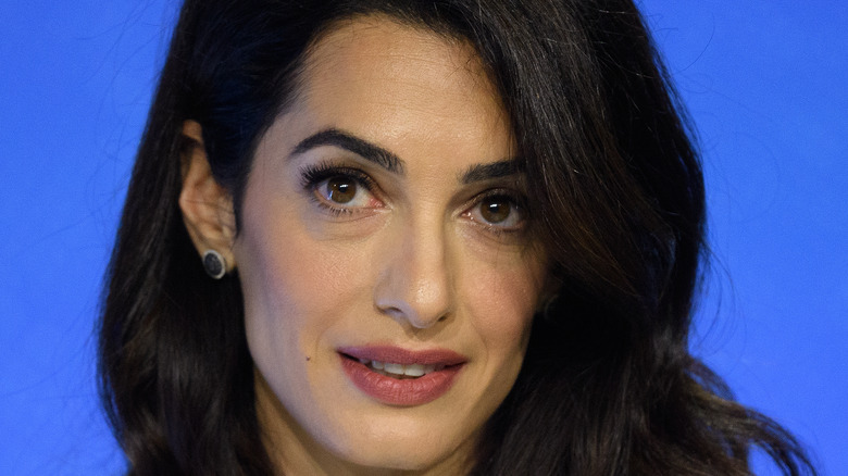 Amal Clooney posing