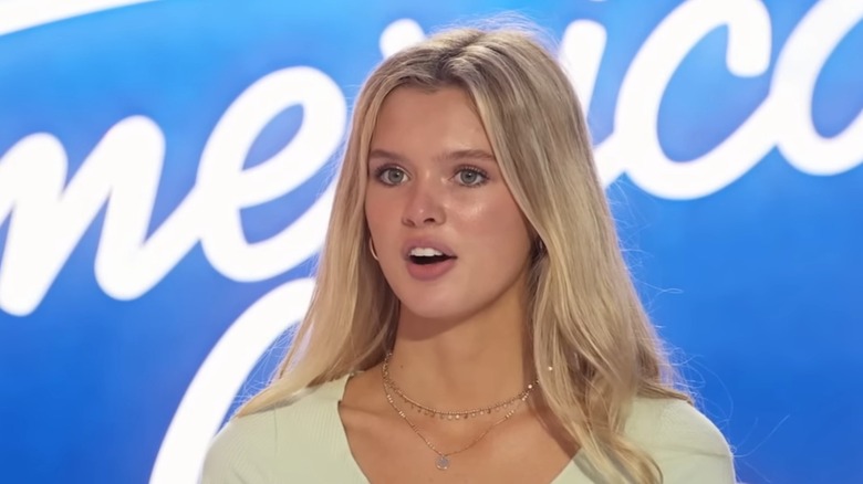 Kenedi Anderson in front of the blue American Idol logo