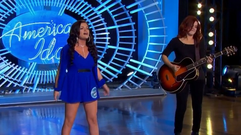 Taryn Coccia singing in front of the American Idol logo while her sister Payton Taylor plays guitar