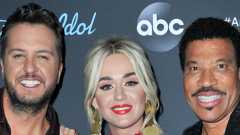 Luke Bryan, Katy Perry, and Lionel Richie's smiling faces posing
