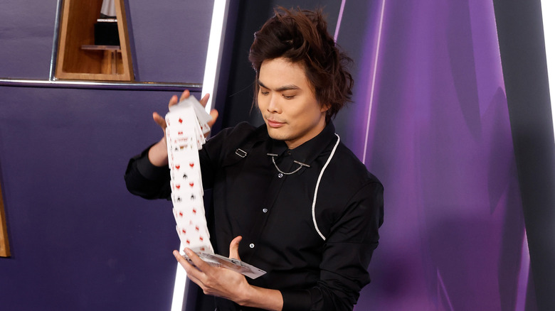 Shin Lim performing a card trick at the American Music Awards in 2025.